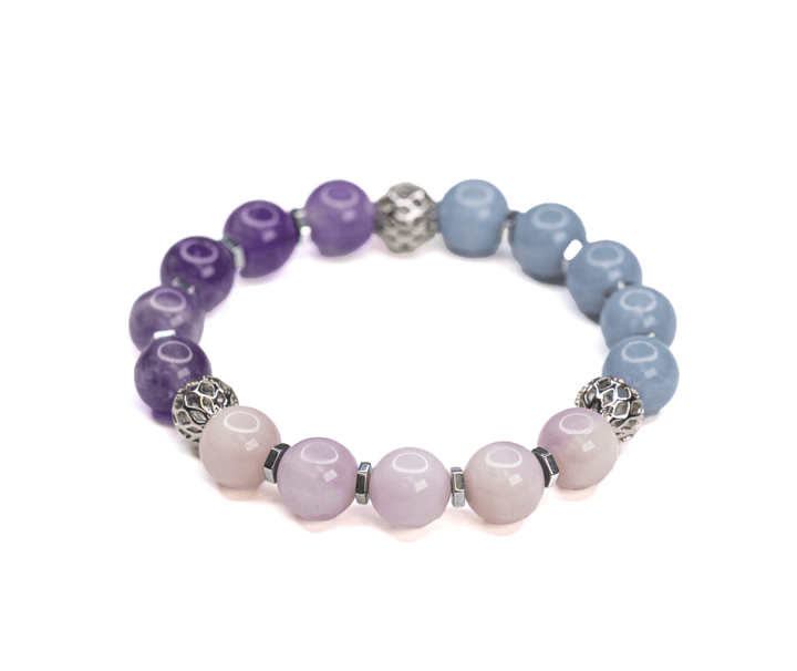 Teach kunzite and amethyst stretch bracelet with decorative spacer beads on white