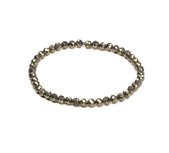 Iron Pyrite Faceted Refined stretch bracelet with small dark metallic beads on white