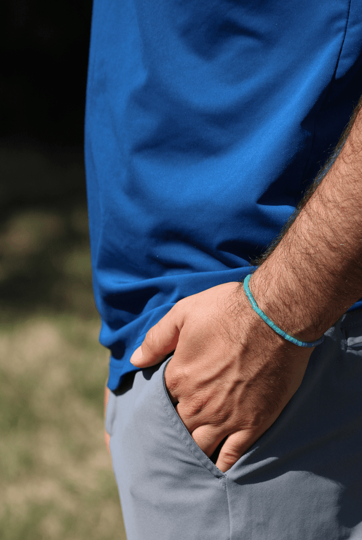Amazonite Heishi bracelet worn on a wrist with hand in pocket outdoors