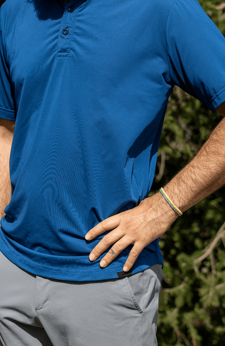 Amazonite Heishi bracelet worn on a wrist with a blue shirt and gray shorts outdoors