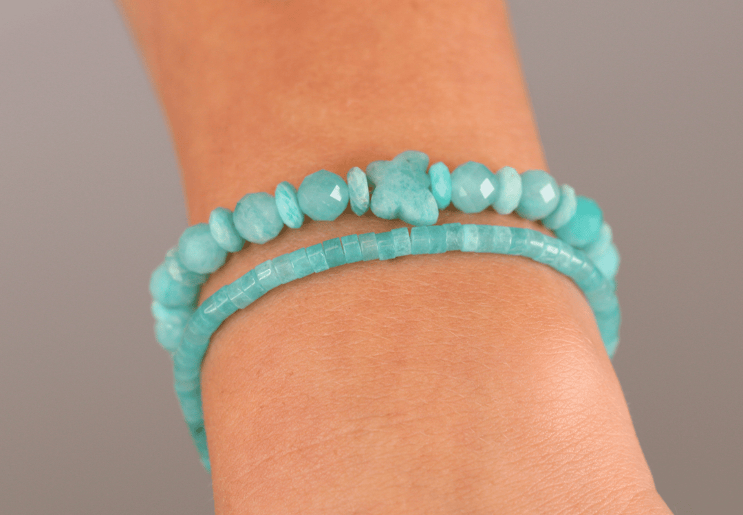 Amazonite Heishi bracelet stacked with an aqua chip bracelet in a close-up wrist view