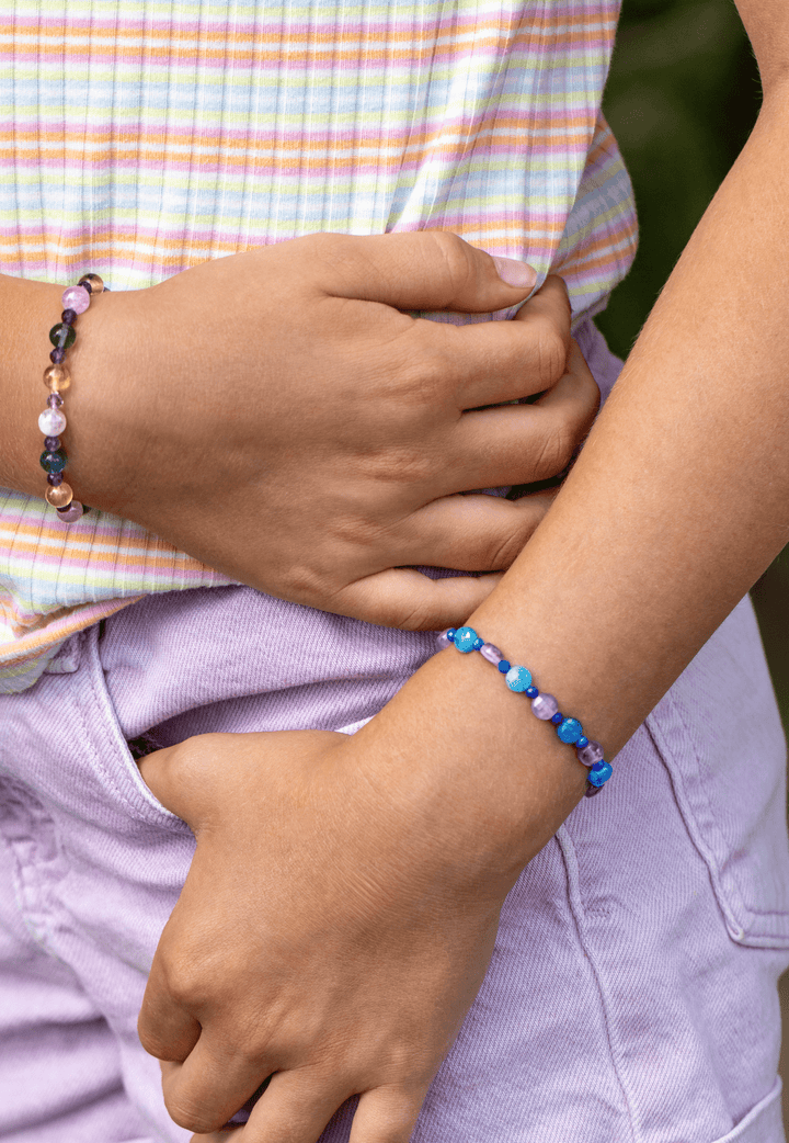 Ocean Blue apatite and amethyst bracelet paired with Fairy fluorite and kunzite bracelet on crossed wrists