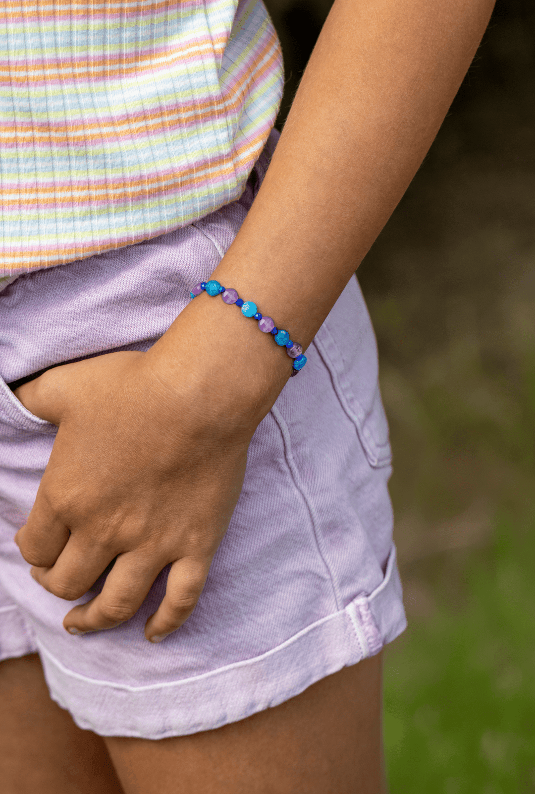 Ocean Blue blue apatite and amethyst bracelet worn with lavender shorts outdoors