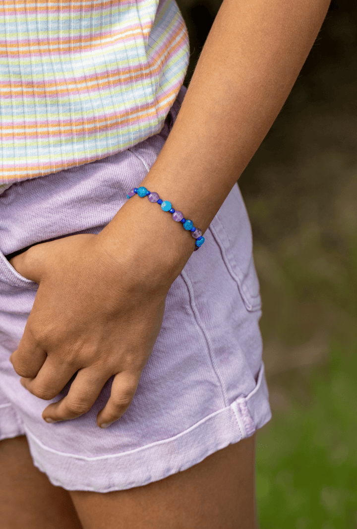 Ocean Blue blue apatite and amethyst bracelet worn with lavender shorts outdoors