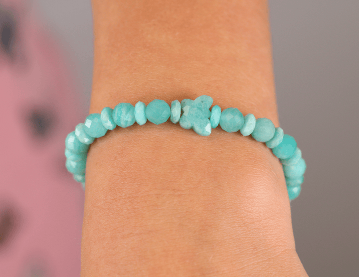 Holly Blue amazonite bracelet worn alone in a close-up wrist view against a pink background