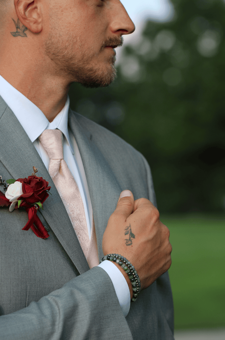 Ivy green chalcedony and kyanite bracelet worn with a gray suit outdoors