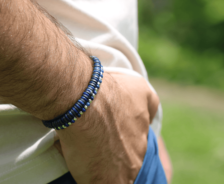 Royal Graphite blue lapis and titanium hematite bracelet on a wrist outdoors