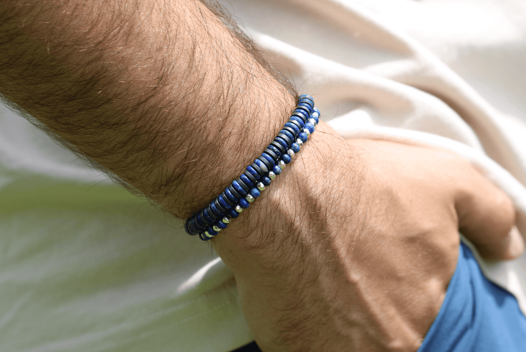 Royal Graphite lapis and titanium hematite bracelet close-up on a wrist over blue shorts
