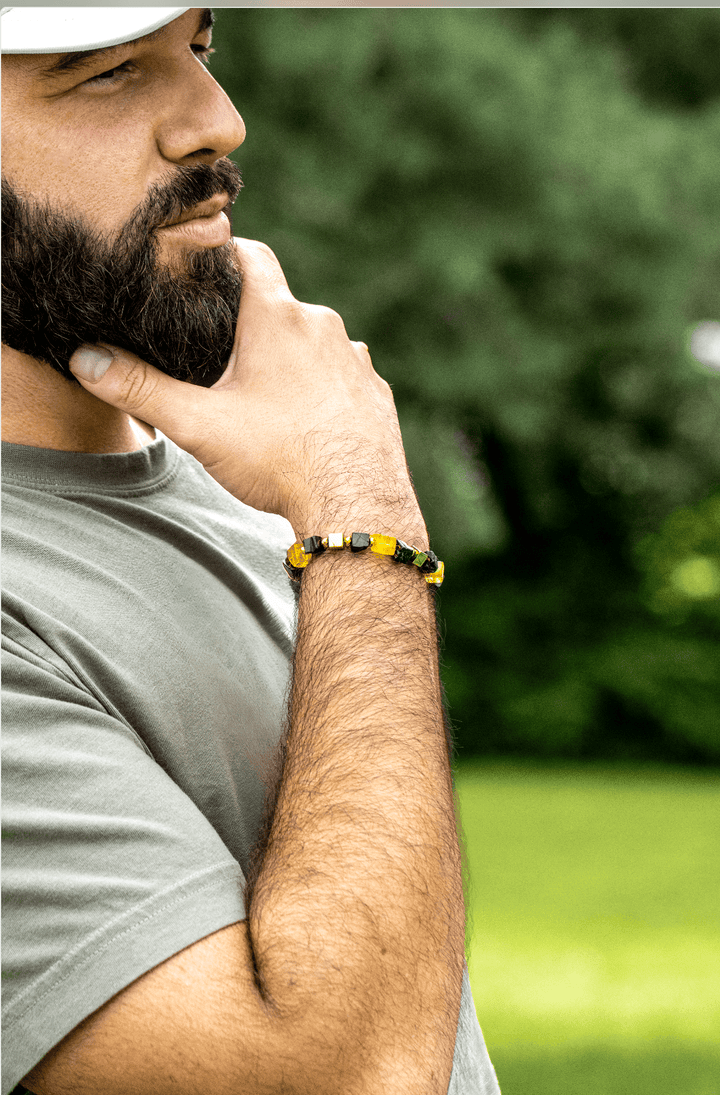 Bearded model wearing the Shep black tourmaline and yellow fluorite bracelet outdoors