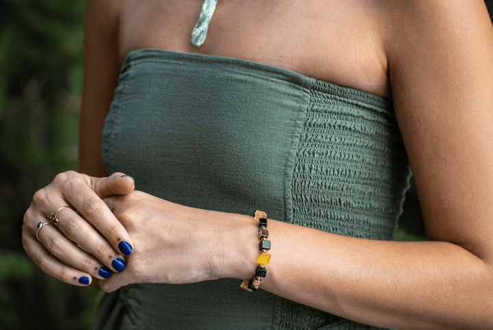 Shep black tourmaline and yellow fluorite bracelet on a model’s clasped hands