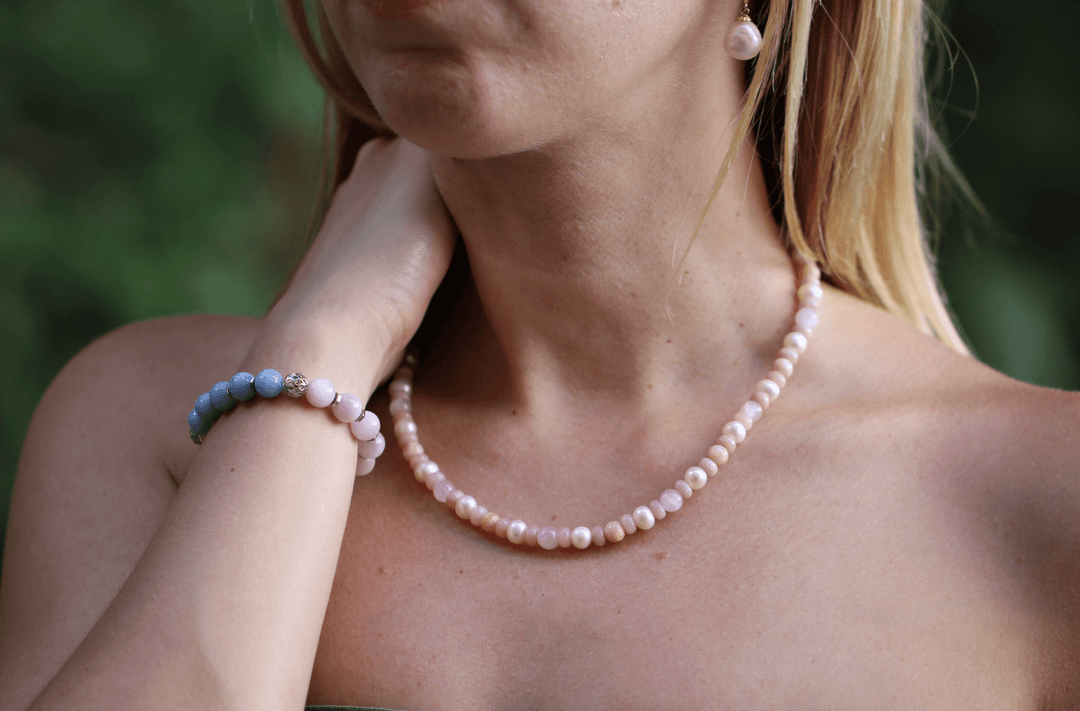 Teach kunzite and amethyst bracelet styled with a pink beaded necklace outdoors